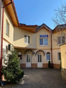 a building with a sign on the front of it at Готель Ніколет in Mukacheve