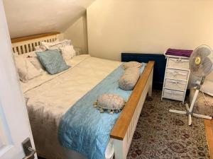 a bedroom with a large bed and a fan at Ms McCreadys Guest House in Doncaster