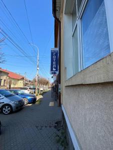 a building with a window on the side of a street at Готель Ніколет in Mukacheve +4 photos