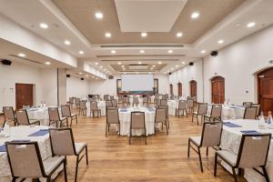 a conference room with tables and chairs and a projection screen at Hilton Hotel Tahiti in Papeete +139 photos