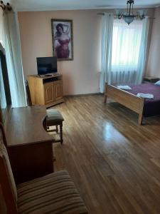 a room with a bed and a table and a couch at Готель Ніколет in Mukacheve
