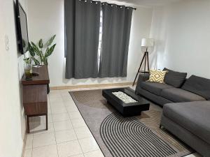 a living room with a couch and a table at Casa Homero 23 in Morelia