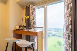 a room with a window with a table and two stools at BreezeVista Getaway in Kaybagal