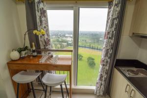 a kitchen with a table and a large window at BreezeVista Getaway in Kaybagal