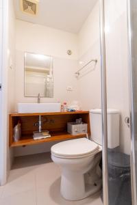 a bathroom with a toilet and a sink at BreezeVista Getaway in Kaybagal