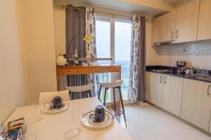 a kitchen with a table and chairs and a window at BreezeVista Getaway in Kaybagal