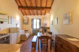 a kitchen with a table and a living room at Podere Lamone a Monticchiello in Monticchiello