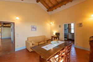 a living room with a table and a couch at Podere Lamone a Monticchiello in Monticchiello