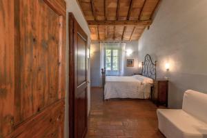 a bedroom with a bed and a window at Podere Lamone a Monticchiello in Monticchiello +27 photos