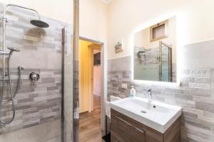 a bathroom with a sink and a shower at Casa Medicea sul canale in Livorno +16 photos