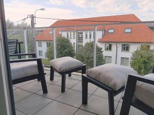 two chairs on a balcony with a view of a building at Zilt 0202 in Westende