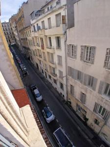 a view of a city street with cars parked next to buildings at hôtel des reformés in Marseille