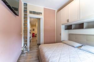 a bedroom with a large bed and a hallway at Casa Medicea sul canale in Livorno