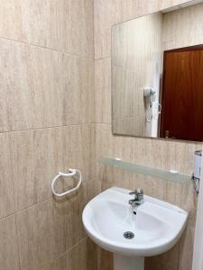 a bathroom with a sink and a mirror at Hotel Sancho in Hospitalet de l'Infant