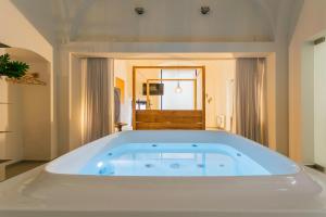 a large white bath tub in a room at Suite 1926 Luxury Room in Triggiano +49 photos