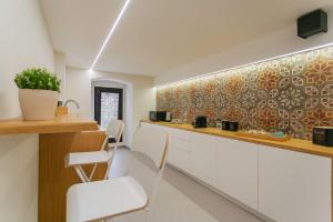 a kitchen with a counter and chairs in a room at Suite 1926 Luxury Room in Triggiano