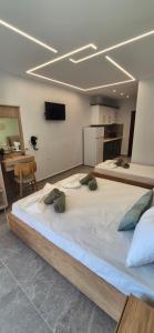 a large bed in a room with a kitchen at Petrino 2 by Vasileia in Sarti