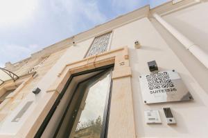 a building with a sign on the side of it at Suite 1926 Luxury Room in Triggiano