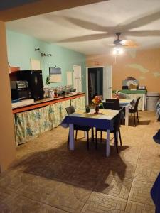 a living room with a table and a kitchen at Fisherman's Inn Hotel Silver Sands, Duncans Bay in Duncans