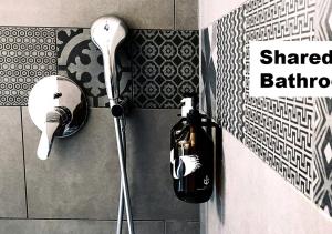 a shower in a bathroom with a hair dryer at Guesthouse fürDich in Zurich
