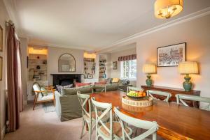 a living room with a table and a couch at West House in High Legh