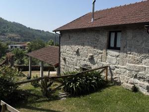 a stone house with a wooden fence in front of it at Serena Nest 01 in Rio Douro