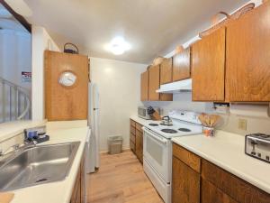 a kitchen with wooden cabinets and a white stove top oven at Spiral Staircase home in Kings Beach