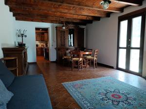 a living room with a table and a dining room at La Caserma -The Barracks in Bobbio Pellice