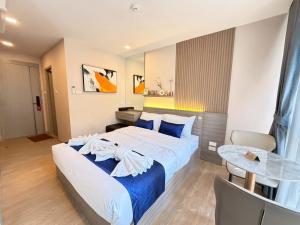 a hotel room with a bed and a table at The Iconic in Pattaya +57 photos