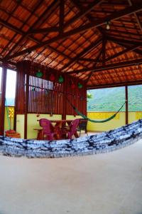 a room with a table and chairs in it at Village vila verde in Itaitu