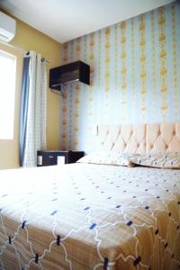a bedroom with a large bed with a white bedspread at Village vila verde in Itaitu +25 photos