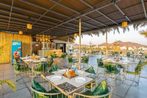 a restaurant with tables and chairs with a view at Sasa resort Udaipur in Udaipur