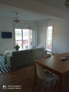a living room with a couch and a table at A Muradana, Aldán in Pontevedra
