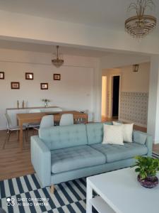 a living room with a blue couch and a table at A Muradana, Aldán in Pontevedra