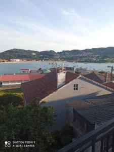 a view of a body of water with buildings at A Muradana, Aldán in Pontevedra