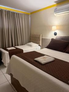 a hotel room with two beds and a window at Hotel Estilo in Arapiraca +20 photos