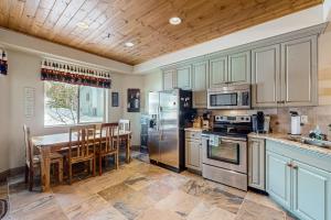 a kitchen with stainless steel appliances and a wooden ceiling at Steps to Brian Head Resort: Ski Home w/ Games in Brian Head