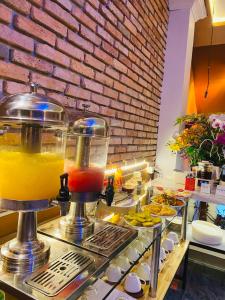 a buffet line with a drink in a blender at Heaven Hostel in Ho Chi Minh City