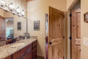 a bathroom with a sink and a mirror at Steps to Brian Head Resort: Ski Home w/ Games in Brian Head +36 photos