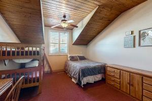a bedroom with a bed and bunk beds in a house at Steps to Brian Head Resort: Ski Home w/ Games in Brian Head
