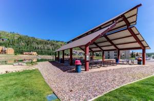 a picnic shelter with benches and tables in a park at Steps to Brian Head Resort: Ski Home w/ Games in Brian Head