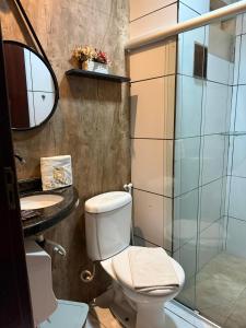 a bathroom with a toilet and a sink and a shower at Hotel Estilo in Arapiraca