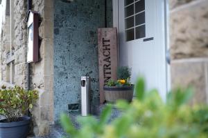 a sign on the door of a house with plants at Hotel Eintracht in Fellbach +12 photos
