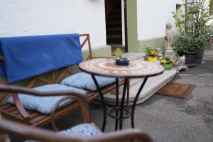 a patio with a table and two chairs and a table and a small table with at Hotel Eintracht in Fellbach