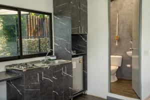 a bathroom with a sink and a toilet at Rocks Glamping - Guatapé, El Peñol in El Peñol +200 photos
