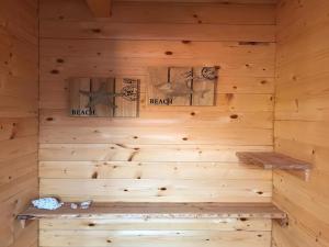 a wooden sauna with a bench in it at Holiday Home Noordwijk near Beach & Sauna in Noordwijk