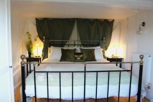 a bedroom with a black bed with a canopy at The Elm, Abbots Ripton in Abbots Ripton
