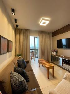 a living room with a couch and a table at Apartamento aconchego na Serra in Bananeiras