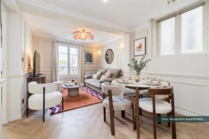 a living room with a table and chairs and a couch at PoeticStay - Neuilly sur Seine - Dulud in Neuilly-sur-Seine +38 photos