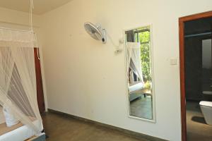 a room with a mirror and a bed and a window at Kithal Ella Station Resort in Ella +144 photos